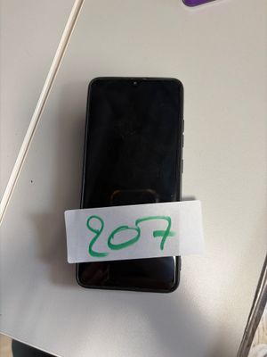 a cell phone with a sticker on it sitting on a table