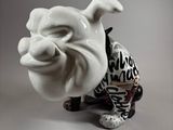 a white bulldog figurine that is sitting on a table
