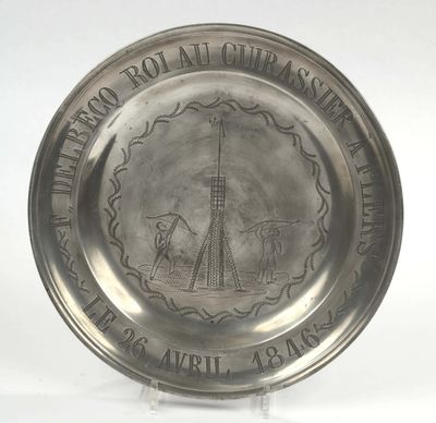 an old silver plate with a picture of a lighthouse on it