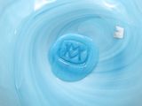 a close up of a bowl with a blue liquid inside of it