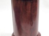 an image of a round wooden table with a black top