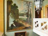 un tableau accroché au mur au-dessus d'un escalier dans une maison