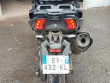 a motorcycle parked in a garage with a lot of luggage on the back of it