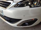 a close up of a white car parked in a parking lot