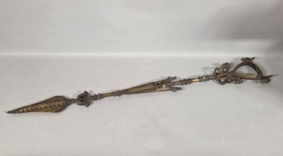 a metal object that is laying on a white surface