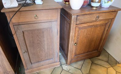 two side tables with vases on top of them
