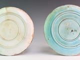 two blue and white plates sitting next to each other