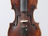 an old violin with a bow hanging from it ' s back