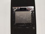 a black and white picture of a cell phone in a box