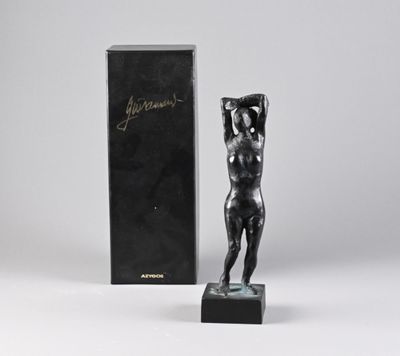a statue of a woman holding a box with a box in the background
