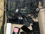 beaucoup d'appareils électroniques dans une boîte posée par terre