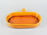 an orange rectangular dish with a lid on a white surface