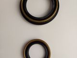 a close up of two black and gold rings on a white surface