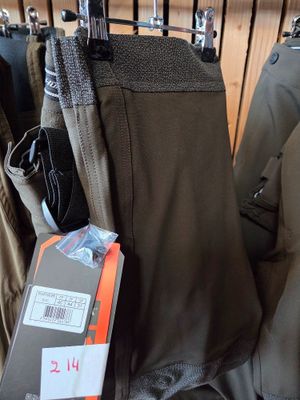several pairs of pants hanging on a rack in a store