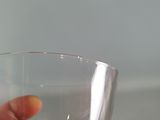 a person holding a glass of wine in their hand