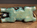 a blue elephant figurine sitting on a wooden table