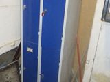 a blue locker in the corner of a room