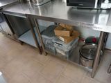 a stainless steel table with a microwave on top of it