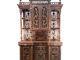 an image of a wooden cabinet with carvings on top of it