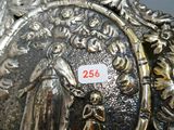 a silver plate with a picture of a woman and a child on it