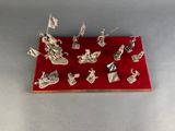 an assortment of silver figurines on a red tray