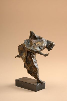 bronze sculpture of a woman holding a dog on a wooden base
