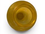 a yellow vase that is sitting on a white surface