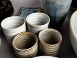 many bowls and cups sitting on a table