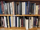 a book shelf with many books on it in a library
