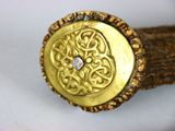 a gold ring with a diamond in the middle of it