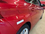 a red car that is parked in a showroom