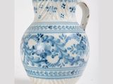 a blue and white vase sitting on a white surface
