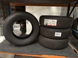 four tires on a shelf in a store