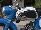 a blue and white motorcycle parked on the side of the street