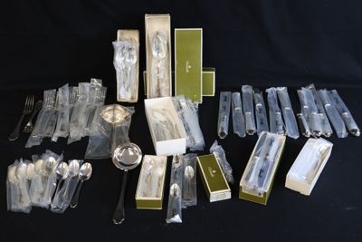 a lot of silverware and spoons on a black table