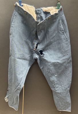 an image of a pair of jeans with holes on them hanging on a wall