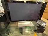a flat screen tv sitting on top of a glass table