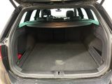 the back of a car with the trunk open and the seats folded down
