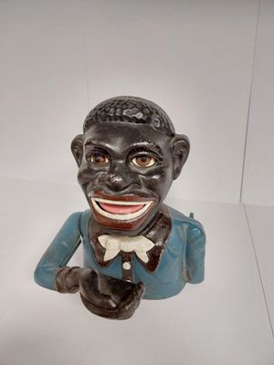 a small statue of a black man with a bow tie