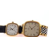 an image of a couple of watches sitting next to each other
