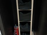 a picture of a closet with a shelf and a bag on the floor