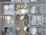 a plastic container filled with lots of coins on a table