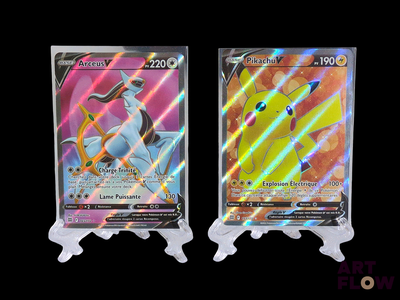 two pokemon cards are displayed on a stand in front of a black background