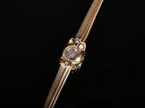a close up of a gold watch on a black background