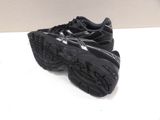 the shoe is black and has a silver logo on the sole