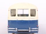 a blue and white toy bus on a white surface