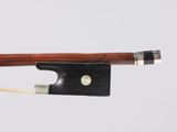 gros plan d'un archet de violon auquel est attachée une corde