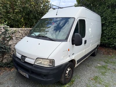 a white van parked next to a stone wall