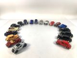 a group of toy cars arranged in a circle on a white surface