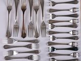 a lot of forks and spoons that are on the table